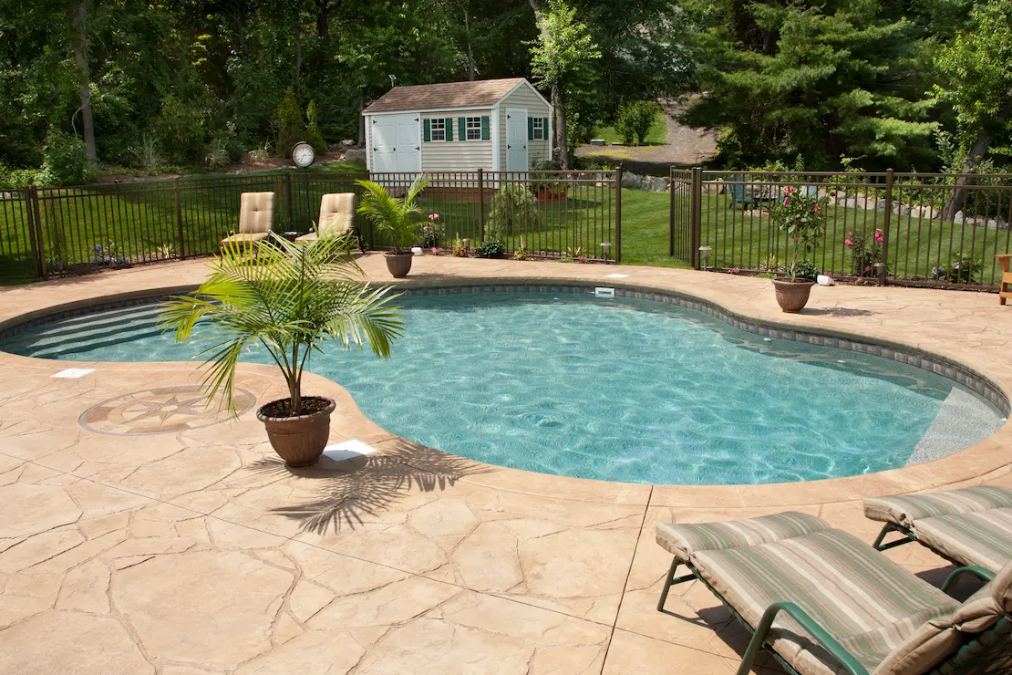 Piscina exterior con revestimiento de hormigón impreso.